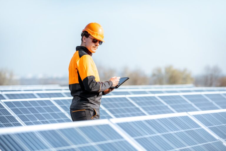 Engineer servicing solar panel on electric plant.jpg